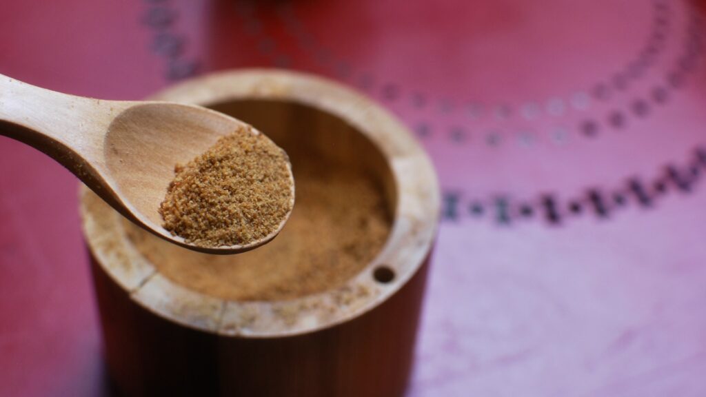 Coconut sugar in a container.