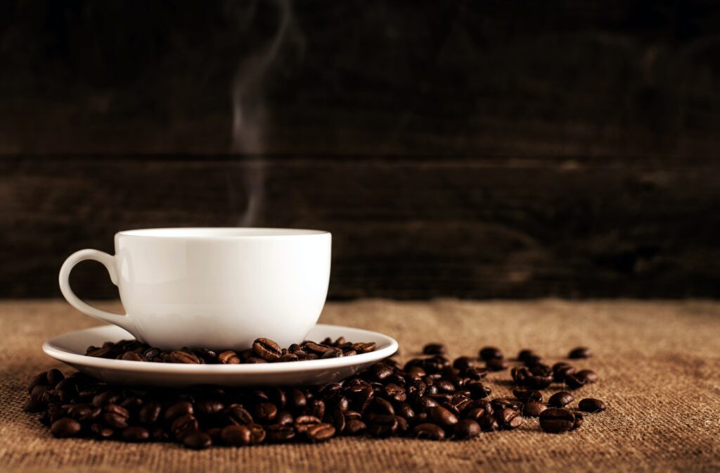 Steaming coffee on top of coffee beans.