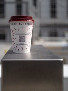 A coffee cup with a QR code printed on it.
