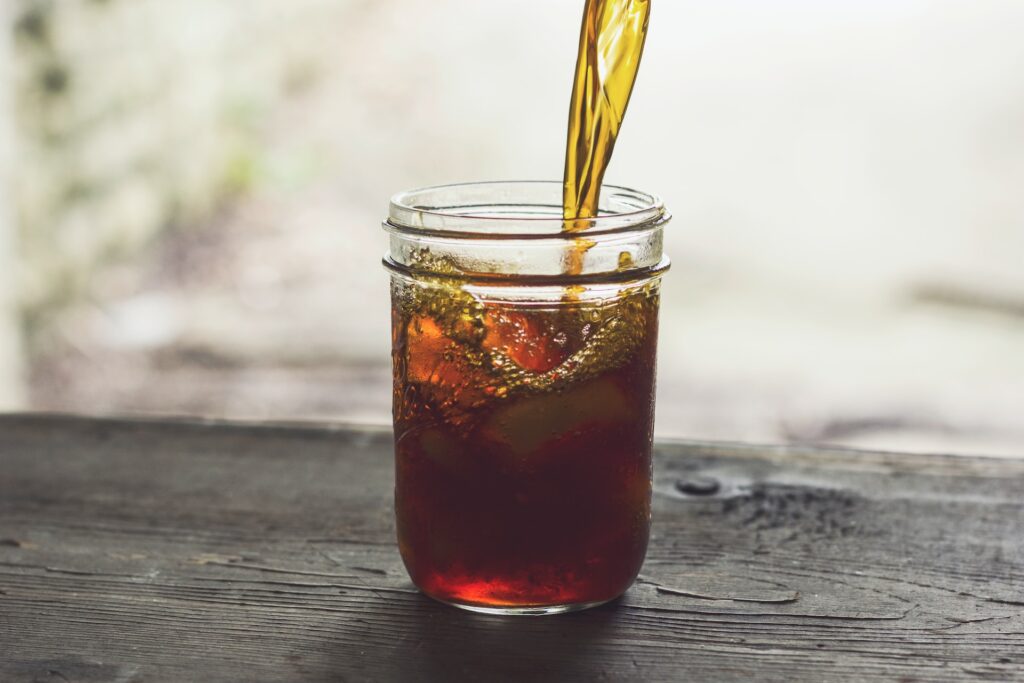 Iced coffee being poured into a jar