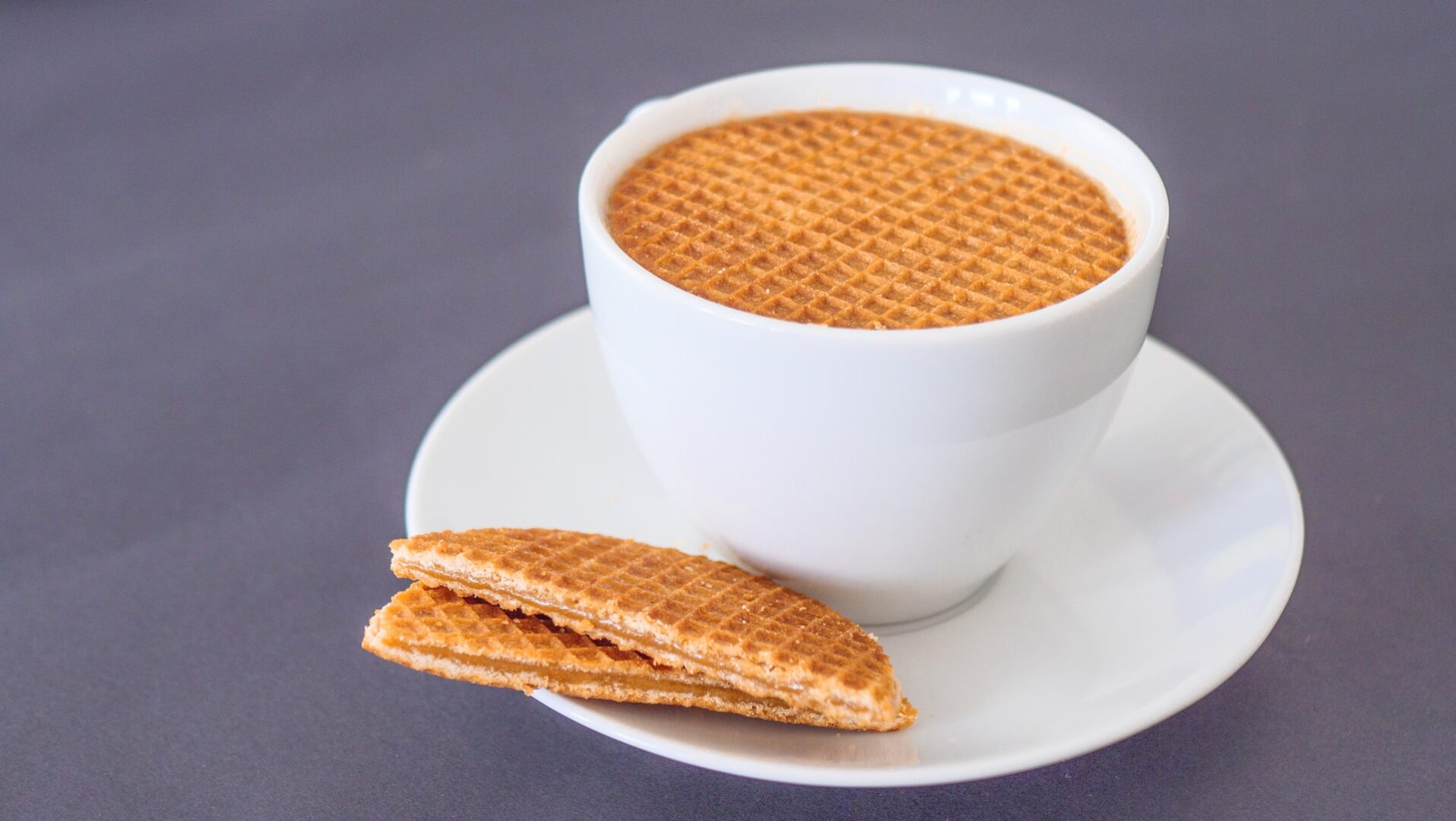Stroopwafel resting on top of a latte